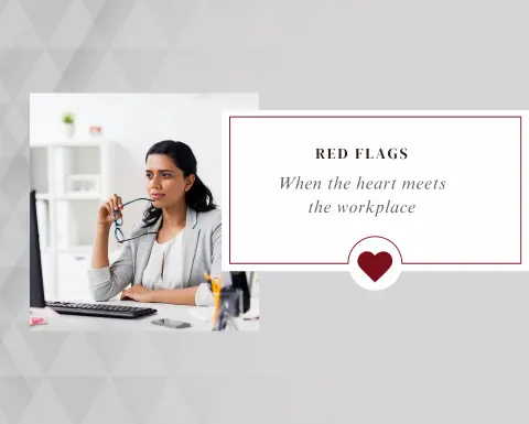 Red Flags: When the Heart Meets the Workplace &mdash; woman working at her desk, blog banner